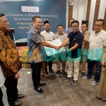 Komisaris PT RBNP, Bambang Setyobudi, menyerahkan surat tanah kepada perwakilan warga Green Garden Regency dan disaksikan Bupati Gresik, Fandi Akhmad Yani. Foto: SYUHUD/BANGSAONLINE