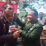 Kasdim 0826/Pamekasan Mayor Inf Imam Suyono menyuapi kue ke Wakapolres Pamekasan Kompol Kurniawan Wulandono di tasyakuran HUT Bhayangkara ke-73.