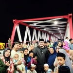 Bupati Kediri Hanindhito Himawan Pramana bersama warga usai meninjau Jembatan Jongbiru Kamis malam (25/7/2024) sebelum dibuka. Foto: Muji Harjita/BANGSAONLINE.com