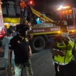 Proses evakuasi truk tronton usai menabrak dua mobil dan tembok milik warga.