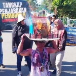 Sejumlah jurnalis di Pamekasan saat menampilkan aksi teatrikal peristiwa dugaan pembunuhan wartawan beserta keluarganya. Foto: DIMAS MS/ BANGSAONLINE