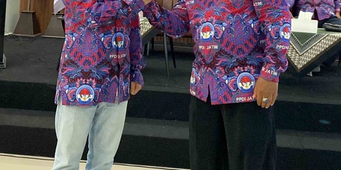 Ketua PPDI Mojokerto Heru Mulyana berjabat tangan dengan Gus Barra setelah mengenakan baju seragam PPDI kepada calon bupati Mojokerto 2004 itu. Foto: bangsaonnline