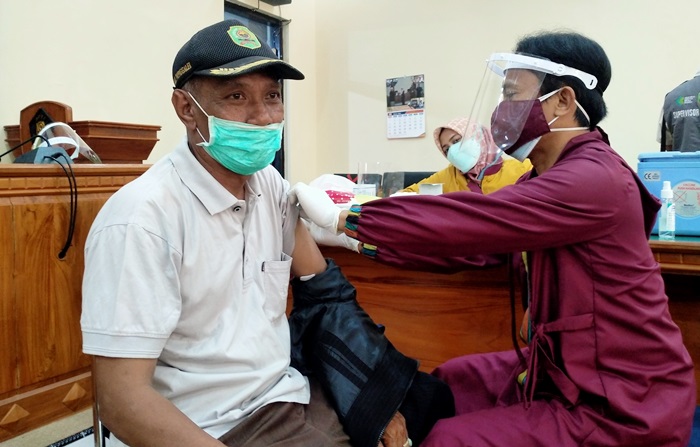 Guswanto saat divaksin tahap II di Aula Gedung DPRD Trenggalek. foto: HERMAN/ BANGSAONLINE