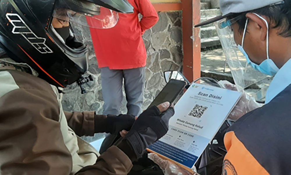 Salah satu pengunjung Wisata Gunung Kelud saat check in dengan scan QR Code PeduliLindungi yang sudah disediakan petugas.