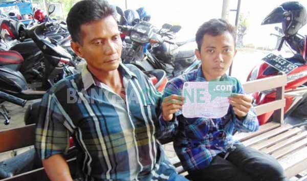 Alex menunjukkan surat tilang didampingi Suprapto, ayahnya. foto: gunadhi/ BANGSAONLINE