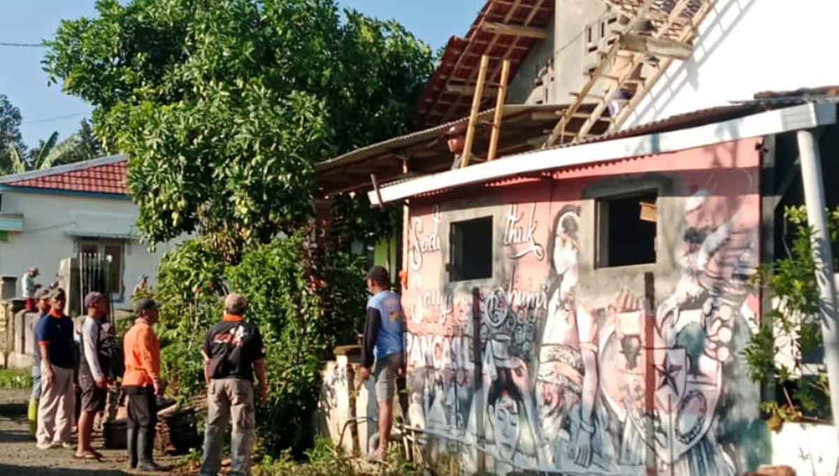 Warga saat bergotong royong memperbaiki rumah yang rusak akibat angin kencang di Kabupaten Kediri. Foto: Ist
