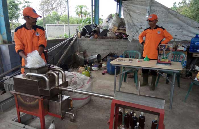 Muryani saat mempraktekkan proses penyulingan sampah plastik menjadi BBM. foto: AKINA/ BANGSAONLINE