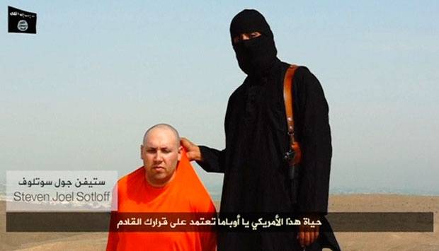 Militan ISIS berbicara di sebelah jurnalis Amerika Steven Sotloff dalam sebuah video yang diunggah ke media sosial pada 19 Agustus 2014. Militan mengatakan nyawa Sotloff bergantung kepada aksi yang dilakukan Amerika di Irak. Amerika masih meneliti keaslian video ini. REUTERS/Tempo