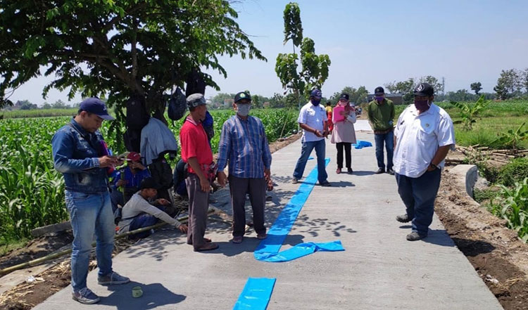 Pembangunan rabat beton bertulang di Desa Alang-Alang Caruban, Jogoroto. (foto: ist)