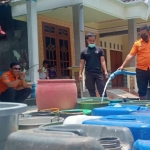 Sejumlah warga saat mengantre untuk mengambil air bersih dari BPBD Jombang.