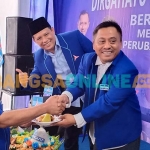 Ketua Bappilu Demokrat Jatim, Samwil, dan Ketua Demokrat Gresik, Supriyanto, saat menyerahkan potongan tumpeng kepada Ketua Fraksi Demakrat DPRD Gresik, Suberi. Foto: SYUHUD/BANGSAONLINE