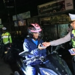 Petugas Satlantas Polres Bangkalan saat memberi hadiah ke salah satu pengendara yang taat lalu lintas