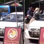 Potongan video saat wanita diduga seorang PNS sedang memecahkan sebuah kaca mobil.