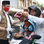 Plt. Wali Kota Pasuruan Raharto Teno Prasetyo, S.T. saat membagikan masker kepada pengendara.