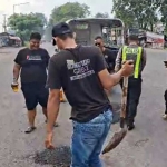 Petugas dari Polsek Krian saat menutup jalan berlubang.