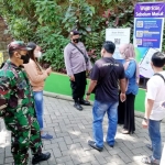 Para petugas sedang mengawasi pengunjung Srambang Park.