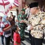 Wakil Bupati Sampang H Fadhillah Budiono membagikan bingkisan dan amplop berisi uang. (foto: bahri/BANGSAONLINE)