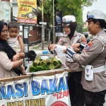 Anggota Satlantas Polres Jombang saat memborong dagangan penjual nasi bakar.