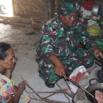 
Seorang Prajurit TNI saat membantu memasak. (Ist).