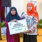 Ketua Umum PP Muslimat NU yang juga Gubernur Jawa Timur periode 2019-2024, Khofifah Indar Parawansa, ketika menyerahkan zakat.
