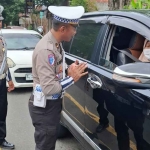 Petugas Satlantas Polres Kediri Kota saat mengingatkan pengemudi agar selalu berhati-hati di jalan. Foto: Ist