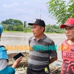 Marlan, salah satu penambang pasir tradisional (kiri) dan Arifin, salah satu warga saat memberi keterangan ke wartawan. Foto: MUJI HARJITA/BANGSAONLINE