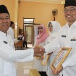 Sekretaris Daerah Kota Pasuruan Drs. H. Bahrul Ulum, M.M. saat menyerahkan penghargaan.