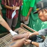 Polisi melakukan identifikasi terhadap tubuh yang gosong kena aliran listrik. foto: eky nurhadi/ BANGSAONLINE