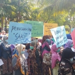 Dengan memakai masker sebagai tanda aksi bisu, emak-emak dan nenek-nerek gelar aksi bisu menolok Poligami dan Perda Poligami di Pemkab Bangkalan dan DPRD. foto: FAUZI/ BANGSAONLINE