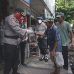 Kapolres Probolinggo Kota, AKBP Ambariyadi Wijaya beserta jajaran saat membagi-bagikan ribuan masker ke masyarakat.