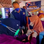 Ketua DPD Partai Nasdem Kabupaten Kediri, Lutfi Mahmudiono, saat meninjau vaksinasi dosis kedua di Balai Desa Wonojoyo, Kecamatan Gurah, Kabupaten Kediri. 