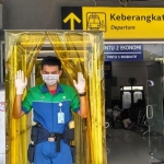 Para pekerja sedang merampungkan pemasangan bilik sterilisasi di Terminal 1 Bandara Juanda. foto: ist.