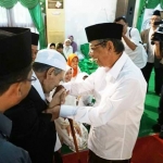 KH Maimun Zuabair (Mbah Moen) saat cium tangan KH A Hasyim Muzadi. foto: istimewa/BANGSAONLINE.COM