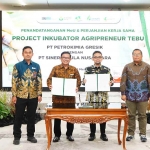 Direktur Utama Petrokimia Gresik, Dwi Satriyo Annurogo (dua dari kiri), bersama Direktur Utama Sinergi Gula Nusantara (SGN), Mahmudi, menunjukan MoU program Agripreniur Tebu. Foto: Ist.