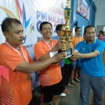 Taufik, Sekretaris PWI Malang Raya saat menyerahkan Piala Wali Kota Malang Cup 2018 kepada sang Juara Polres Malang Kota, Sabtu (24/11). Foto: IWAN I/BANGSAONLINE