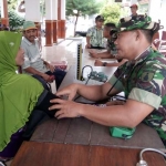 Tim Poskes Kodim Tuban saat memeriksa kesehatan warga Tambakrejo. foto: SUWANDI/ BANGSAONLINE
