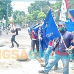 Puluhan buruh saat menggelar aksi di Halaman Disnaker Jombang. foto: AAN AMRULLOH/ BANGSAONLINE