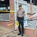Anggota kepolisian saat melakukan olah TKP di rumah Kades Pakel, Kecamatan Gucialit, Lumajang. Foto: Ist.