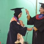 Pj. Wali Kota Kediri Zanariah saat mewisuda salah satu wisudawati. (Ist).