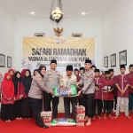 Kapolres Kediri Kota saat menyerahkan santunan secara simbolis kepada Pimpinan Panti Asuhan Yayasan Mutiara Gemilang Banaran, KH. Umar Faruq. Foto: Ist
