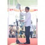 Presiden Jokowi saat memperlihatkan sertifikat tanah di depan masyarakat yang akan menerimanya.