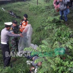 Petugas saat mengevakuasi korban kecelakaan kereta api di rel penyeberangan tak berpalang pintu di Dusun Bean, Desa Jabon, Kecamatan/Kabupaten Jombang, Kamis (5/1) pagi. foto: ROMZA/ BANGSAONLINE