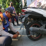 Petugas Dishub menggembok kendaraan yang kedapatan parkir sembarangan