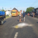Warga saat mengevakuasi korban kecelakaan yang terlindas truk di Jombang.
