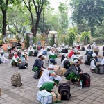 Para santri berkumpul di halaman parkir Masjid Agung Kabupaten Sidoarjo dengan jarak 1 meter sebelum menjalani screening kesehatan.