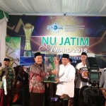 Ketua PWNU Jatim saat menyerahkan tropi bergilir NU Jatim Award kepada Ketua PCNU Sidoarjo. Foto: YUDI A/BANGSAONLINE