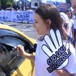 Adam Pawet Krolak asal Polandia dan Anastasiia Prilipko asal Rusia memberikan pengguna jalan buah tangan berupa stiker bertulisan "Ojo Lali Nyoblos!" foto: devi/ BANGSAONLINE