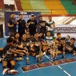 Para pemain dan pelatih futsal SMA Kholilurrohman Konang foto bersama sambil memamerkan trofi.