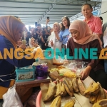 Cagub Jawa Timur, Khofifah Indar Parawansa saat mengunjungi stan penjual makanan tradisional. Foto: Devi Fitri Afriyanti/BANGSAONLINE