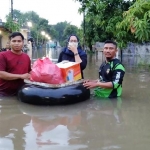 Sejumlah relawan saat mengirim bantuan nasi bungkus kepada warga terdampak banjir di Kecamatan Gempol.